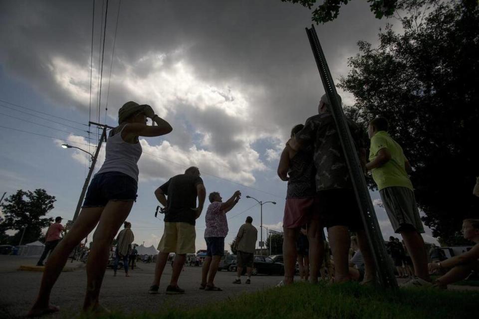 Clouds prevent a crowd gathered in a city park near the Shadow Fest live music stage to watch the complete Solar Eclipse in Carbondale, Illinois.