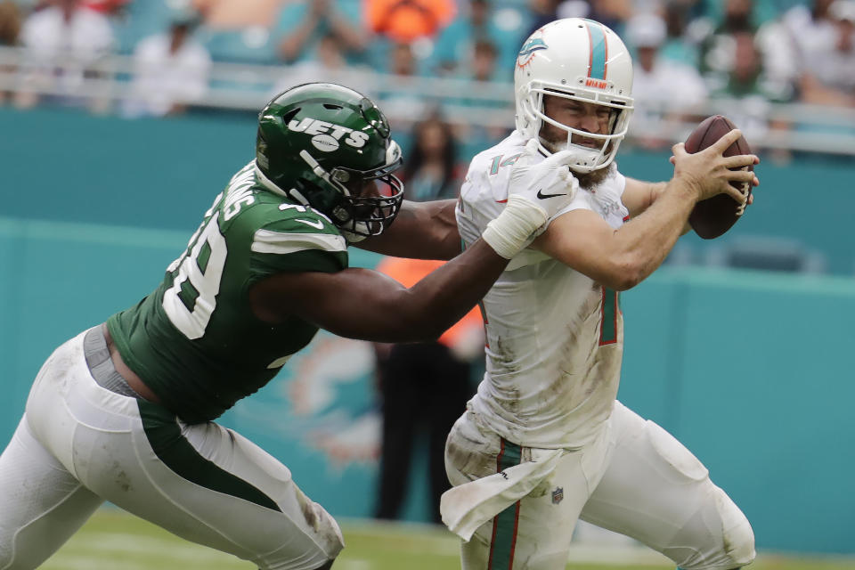 New York Jets outside linebacker Jordan Jenkins (48) sacks Miami Dolphins quarterback Ryan Fitzpatrick (14) during the second half of an NFL football game, Sunday, Nov. 3, 2019, in Miami Gardens, Fla. (AP Photo/Lynne Sladky)