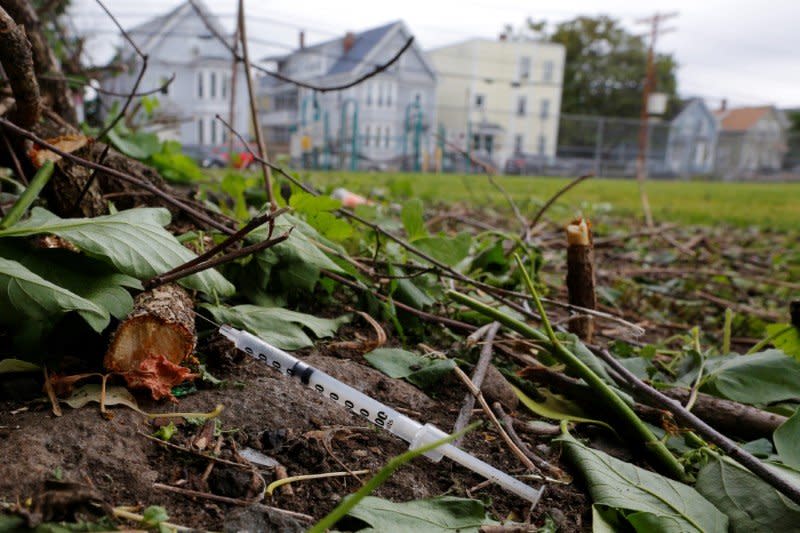 A used needle sits on the ground in a park in Lawrence, Massachusetts, U.S., May 30, 2017, where individuals were arrested earlier in the day during raids to break up heroin and fentanyl drug rings in the region, according to law enforcement officials.   REUTERS/Brian Snyder