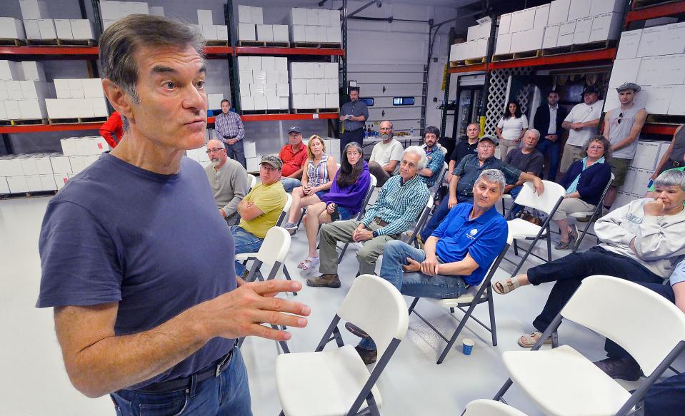 Republican U.S. Senate candidate Dr. Mehmet Oz, left, leads a roundtable discussion focused on agriculture, small businesses and the Pennsylvania economy at Mobilia Fruit Farm in North East Township on June 14, 2022. Pennsylvania Farm Bureau members met in a grape-processing room at Mobilia, owners of Arrowhead Wine Cellars, to discuss agriculture and trade policies.