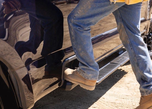 A new built-in step feature on the 2023 Ford Super Duty pickup attracted attention during America's Thanksgiving Parade in Detroit, said engineer Peter Bejin, who rode in the vehicle and listened to paradegoers on Thursday, Nov. 24, 2022. The step provides access to the truck bed without needing to lower the tailgate.