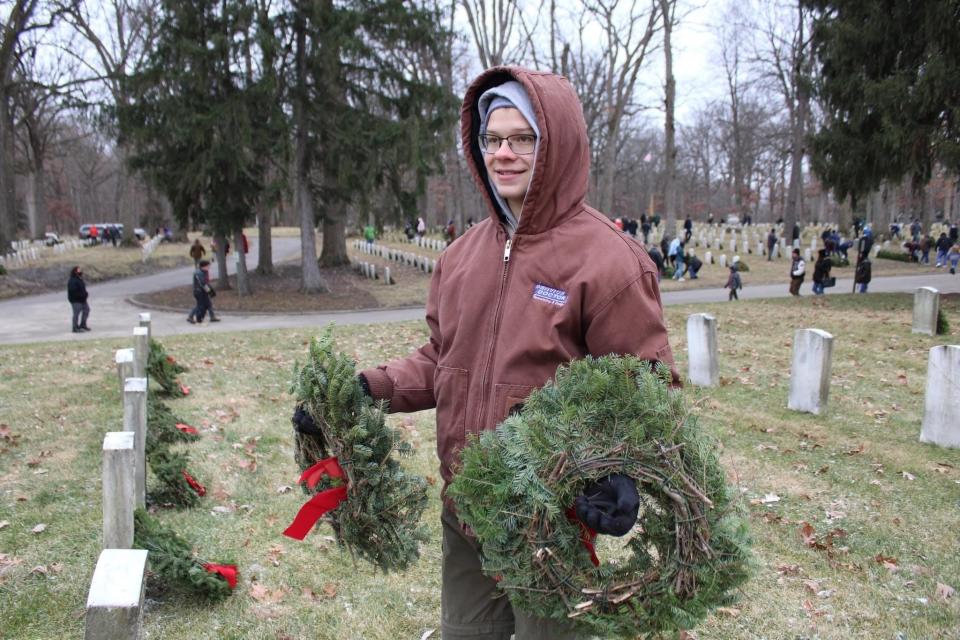 Owen Babiak, a member of Boy Scout Troop 372 from Lafayette, is one of six troop members who helped decorate grave sites Saturday, Dec. 17, 2022,  at the Indiana Veterans Home with Christmas wreaths.