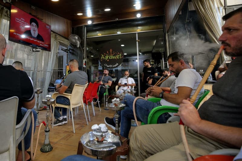 Lebanese supporters of pro-Iranian Hezbollah listen to a televised speech of the party leader Hassan Nasrallah at a cafe in Beirut. Nasrallah said the pager attack which has killed 37 people and injured thousands crossed a 'red line' as fears of a wider war mount. Marwan Naamani/ZUMA Press Wire/dpa