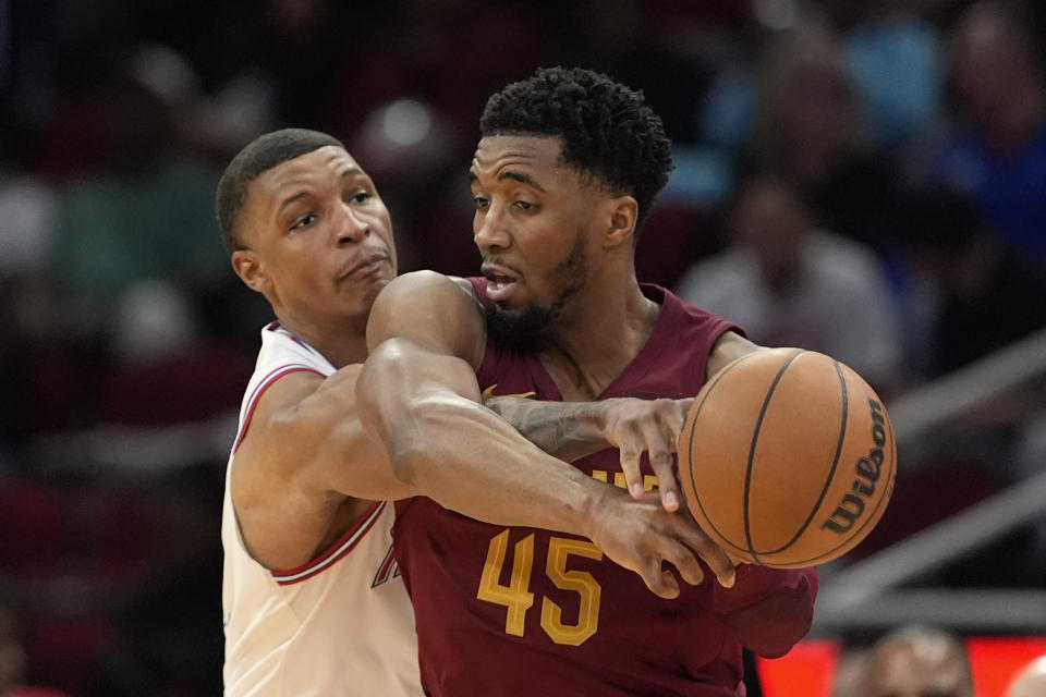 Houston Rockets' Jabari Smith Jr., left, knocks the ball away from Cleveland Cavaliers' Donovan Mitchell (45) during the second half of an NBA basketball game Saturday, March 16, 2024, in Houston. The Rockets won 117-103. (AP Photo/David J. Phillip)