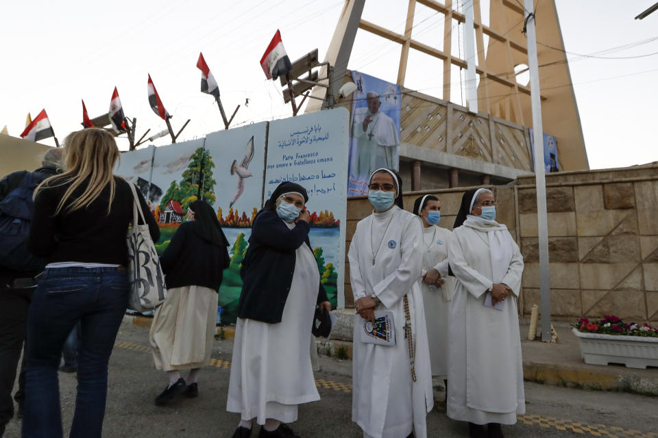 Nuns wait to see Pope Francis outside the Sayidat al-Nejat (Our Lady of Salvation) Cathedral, in Baghdad, Iraq, Friday, March 5, 2021. Pope Francis has honored victims of one of Iraq's most brutal massacres of Christians by Islamic militants. He is making a visit to Baghdad's Our Lady of Salvation Cathedral, where he has prayed and spoke with priests, seminarians and religious sisters. In 2010, al-Qaida-linked militants gunned down worshippers at the church in an attack that left 58 people dead. (AP Photo/Andrew Medichini)