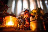 A candle sits as people gather outside of the U.S. Supreme Court following the death of U.S. Supreme Court Justice Ruth Bader Ginsburg, in Washington