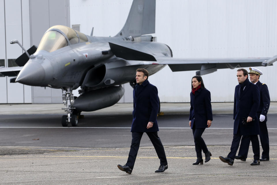 French President Emmanuel Macron, left, arrives to review the troops before his New Year address to the French Army, Friday, Jan. 20, 2023 at the Mont-de-Marsan air base, southwestern France. President Emmanuel Macron is expected to unveil his vision for modernizing the military in his nuclear-armed country, taking into account the impact of the war in Ukraine and evolving threats around the world. (AP Photo/Bob Edme, Pool)