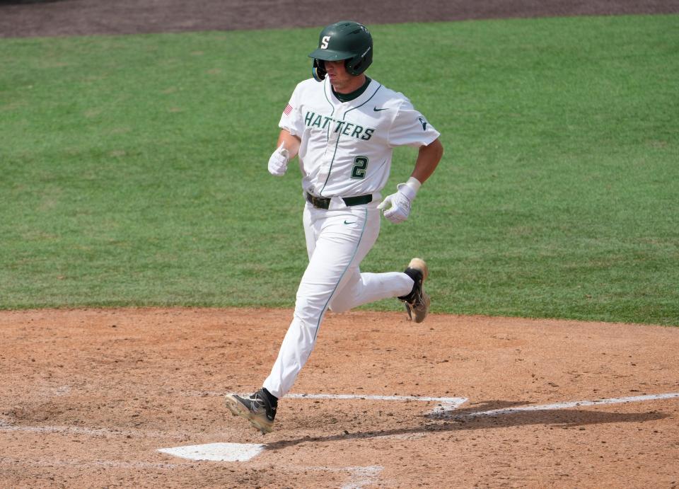 Stetson's Cameron Hill steps on home plate to score a run during a game with Austin Peay at Melching Field in DeLand, Thursday, May 25, 2023.