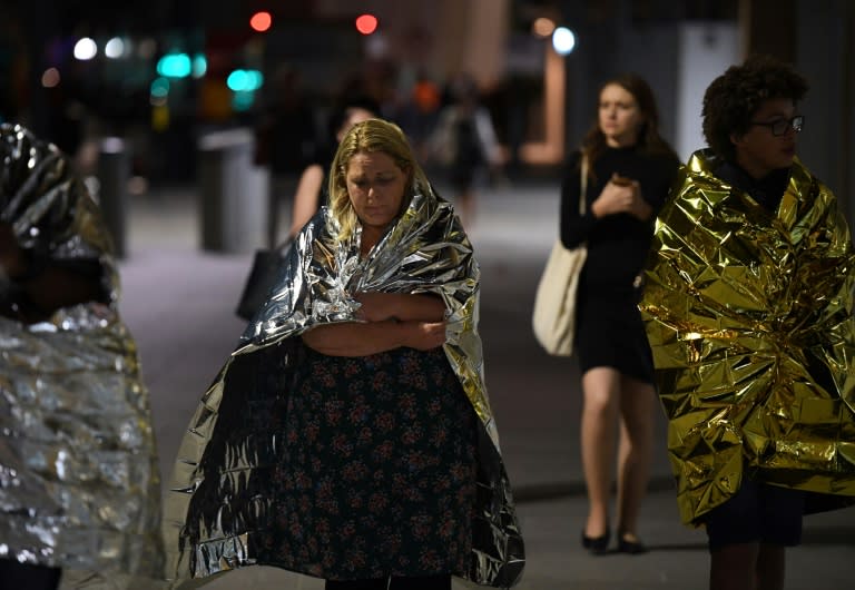 Members of the public, wrapped in emergency blankets, leave the scene of the terror attack on London Bridge in central London on June 3
