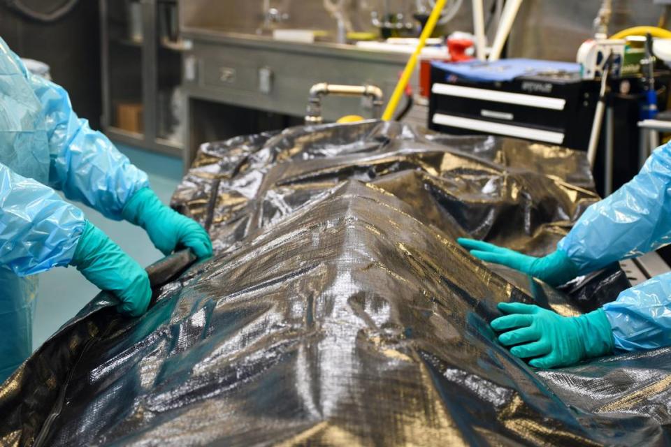 Two staff members at the chief medical examiner’s office in Raleigh prepare to transport a body.