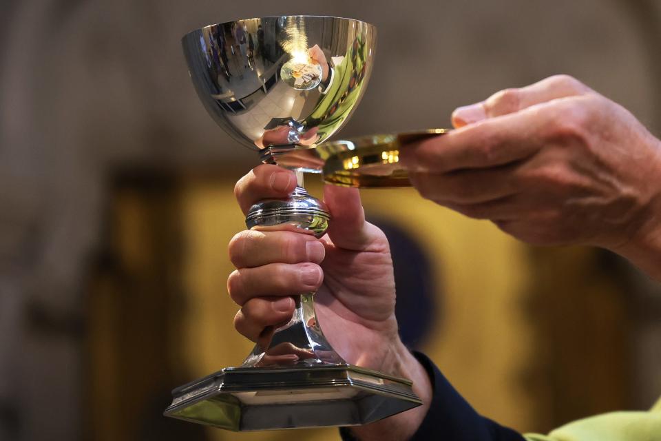 Rev. Canon Patrick Malloy prepares to give communion during a Holy Eucharist Service in the Chapel of Saint Martin at the Cathedral Of St. John the Divine in 2021 in New York City.