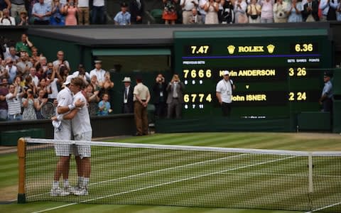South Africa's Kevin Anderson (R) embraces US player John Isner after winning their men's singles semi-final match on the eleventh day of the 2018 Wimbledon Championships at The All England Lawn Tennis Club in Wimbledo - Credit: Getty images