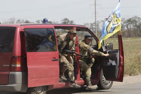 Soldiers of Ukrainian self-defence battalion "Azov" get out of a car as they arrive at a checkpoint in the southern coastal town of Mariupol, September 5, 2014. REUTERS/Vasily Fedosenko