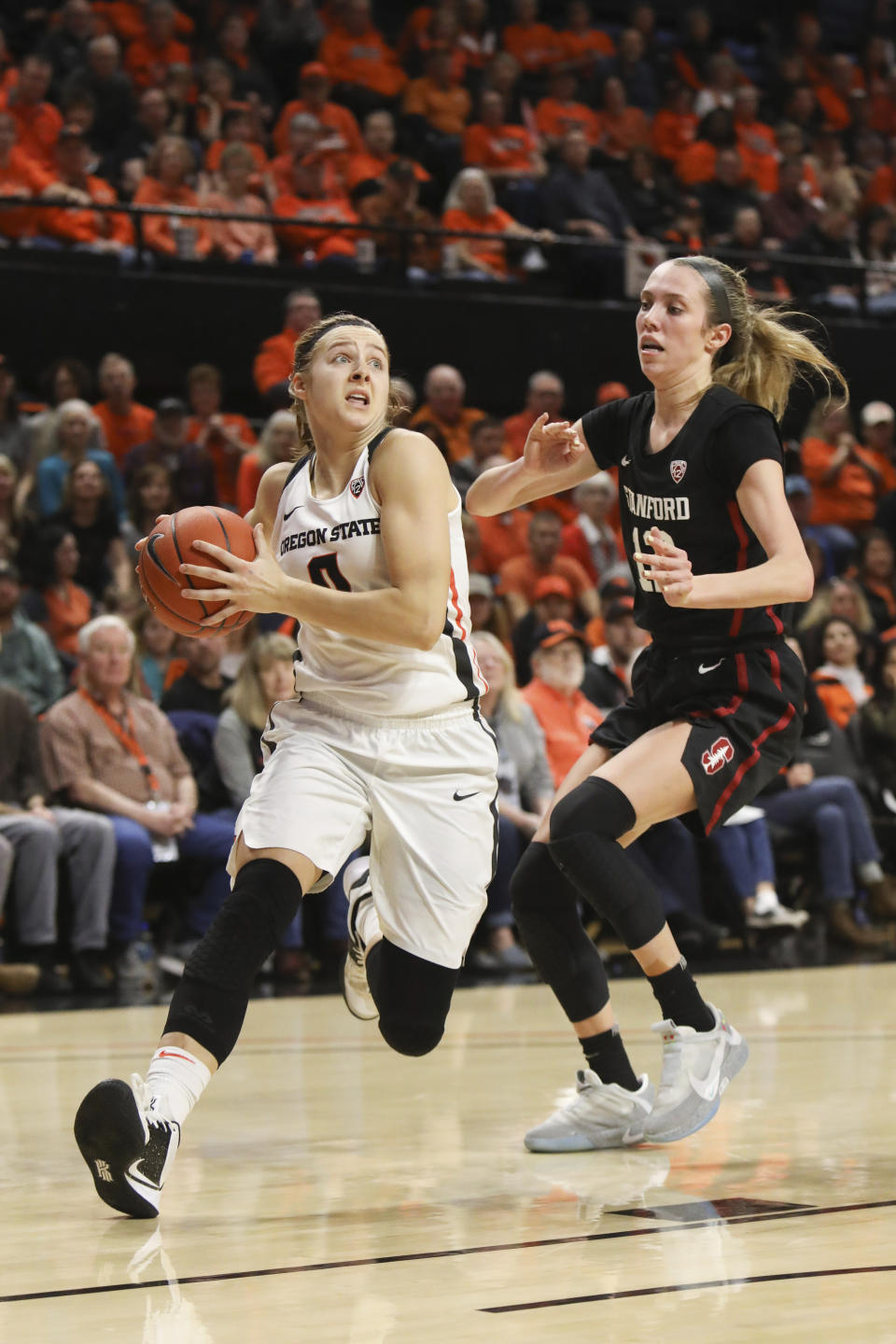 Oregon State's Mikayla Pivec (0) slips around Stanford's Lexie Hull (12) for a layup during the first half of an NCAA college basketball game in Corvallis, Ore., Sunday, Jan. 19, 2020. (AP Photo/Amanda Loman)