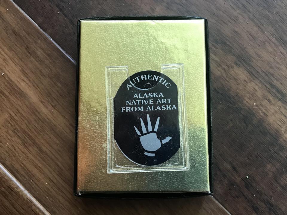 gold souvenir box with "alaska native" silver hand on it