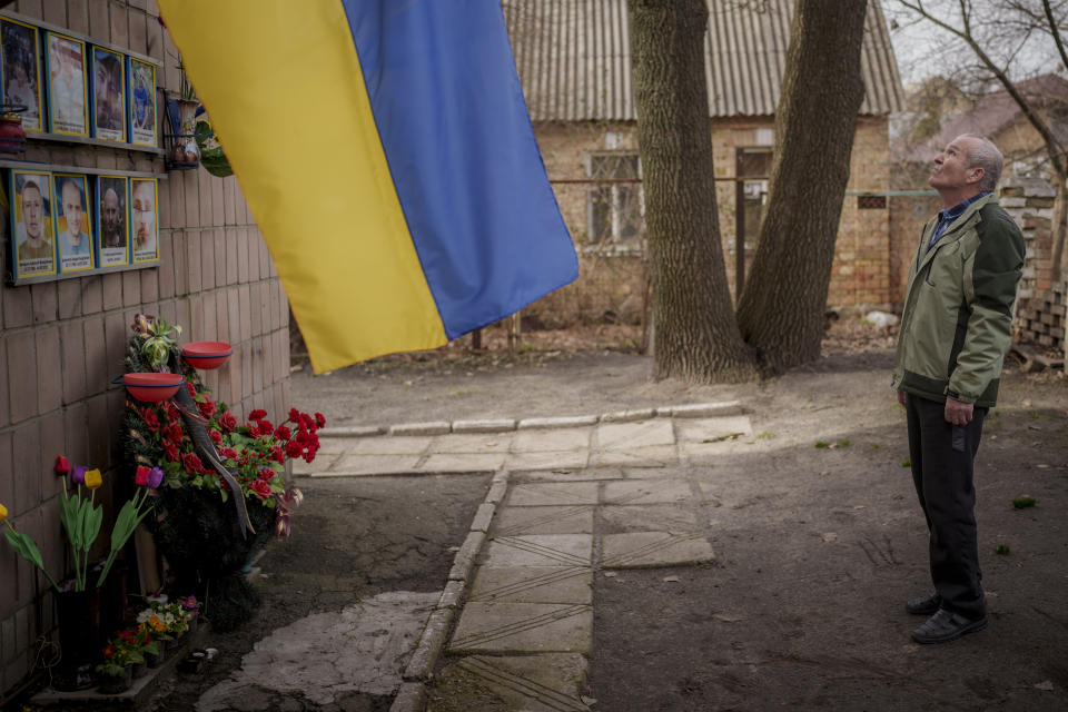 Oleksandr Turovskyi, whose 35-year old son Sviatoslav was among eight men executed in a vacant lot in the suburb of Bucha in March 2022, takes a moment at a memorial on the lot where his son was found in Bucha, Ukraine, Saturday, March 30, 2024. Days after Russian forces withdrew from the area in late March, in the dramatic first weeks of the full-scale invasion, a photo taken by AP Photographer Vadim Ghirda revealed what happened to the eight men. (AP Photo/Vadim Ghirda)