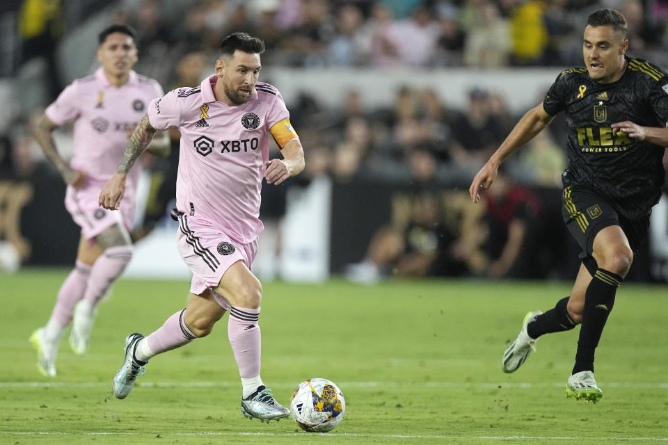 Inter Miami forward Lionel Messi, center, moves the ball as Los Angeles FC defender Aaron Long, right, chases during the first half of a Major League Soccer match Sunday, Sept. 3, 2023, in Los Angeles. (AP Photo/Mark J. Terrill)