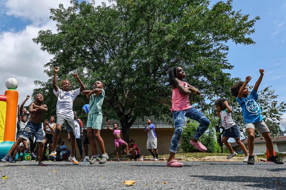 Children dance during a community back-to-school drive Aug. 26, 2023, at Best Night Inn in New Castle.