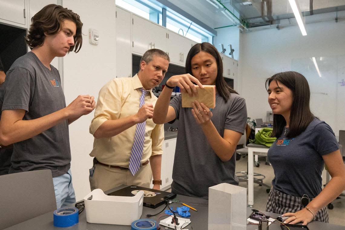 Ransom Everglades School physics teacher Paul Natland (left middle) watches as his senior students (L-R) Adrian Stone Perez, Theodore Ma and Dadly Leon prepare to test their rocket payload in advance of an actual launch into space on a Blue Origin’s New Shepard rocket with a simulation on Friday, Sept., 18, 2022.