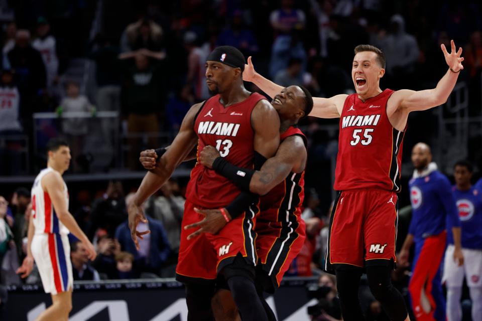 Miami Heat center Bam Adebayo celebrates with guards Terry Rozier (2) and Duncan Robinson (55), after he hit a 3-point basket at the buzzer for a 104-101 win against the Detroit Pistons at Little Caesars Arena in Detroit, March 17, 2024.