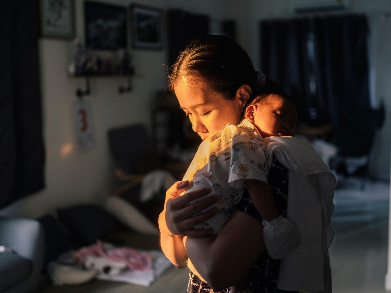 Mom holding her newborn baby.