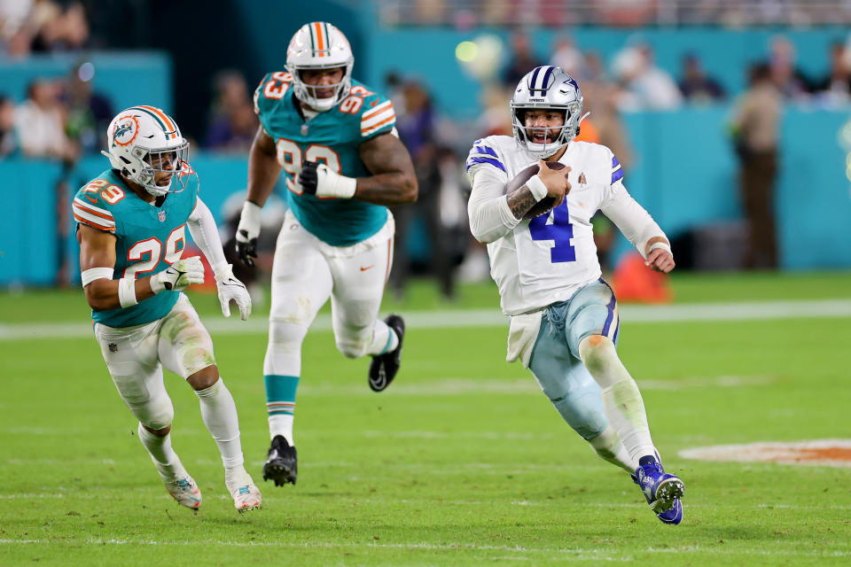 MIAMI GARDENS, FLORIDA - DECEMBER 24: Dak Prescott #4 of the Dallas Cowboys runs the ball while being chased by Brandon Jones #29 of the Miami Dolphins during the fourth quarter at Hard Rock Stadium on December 24, 2023 in Miami Gardens, Florida. (Photo by Stacy Revere/Getty Images)