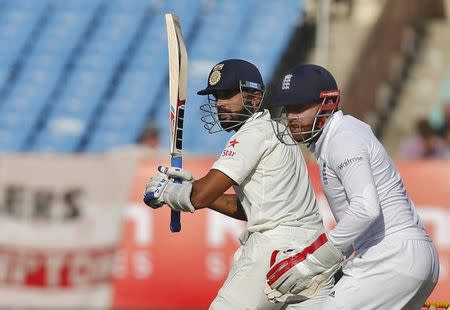 First Test cricket match - Saurashtra Cricket Association Stadium, Rajkot, India - 10/11/16. India's Murali Vijay (L) plays a shot watched by England's Jonny Bairstow. REUTERS/Amit Dave