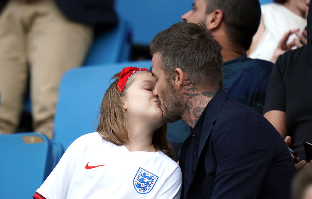 David Beckham isn't going to let trolls or Piers Morgan stop him kissing daughter Harper on the lips [Photo: Getty]