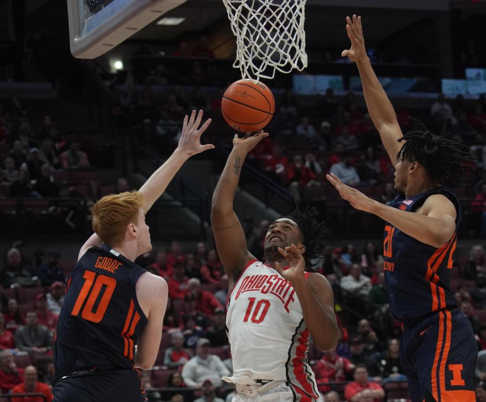 Feb 26, 2023; Columbus, OH, USA; Ohio State Buckeyes forward Brice Sensabaugh (10) shoots past Illinois Fighting Illini guard Luke Goode (10) and Illinois Fighting Illini forward Connor Serven (2) during NCAA basketball game Feb. 26, 2023 at Value City Arena. Mandatory Credit: Doral Chenoweth-The Columbus Dispatch