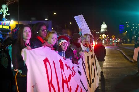 Protestors block traffic on Washington Avenue during a candlelight vigil for Tony Robinson Jr. in Madison, Wisconsin March 8, 2015. REUTERS/Ben Brewer