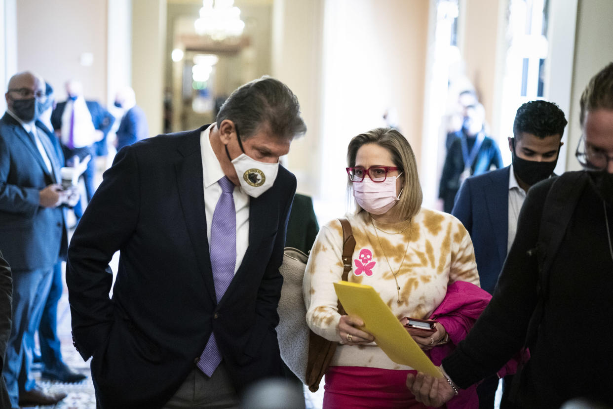 WASHINGTON, DC - NOVEMBER 16: Sen. Joe Manchin, D-W.Va., and Sen. Kyrsten Sinema, D-Ariz., depart after a Democratic policy luncheon on Capitol Hill on Tuesday, Nov. 16, 2021 in Washington, DC. (Photo by Jabin Botsford/The Washington Post via Getty Images)