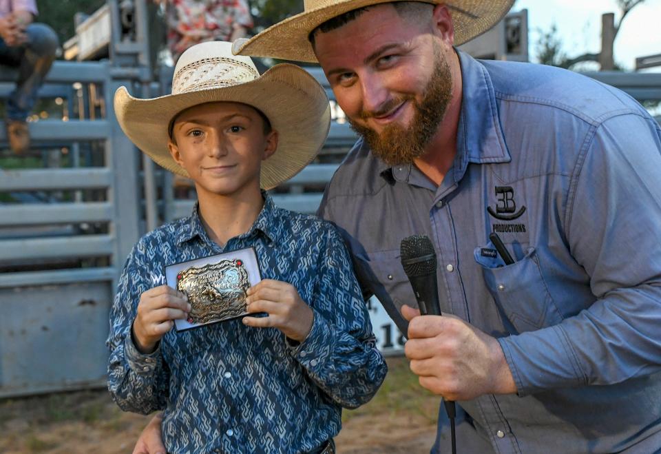 Despite his short ride, Trip Burley (left) is awarded with the overall series buckle by Tyler Barnes, of Rockin 3B Productions, at the Fellsmere Riding Club on Saturday, Sept. 10, 2022, in Fellsmere.