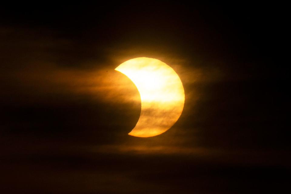 <p>Kena Betancur/AFP/Getty</p> A solar eclipse in New York City on June 10, 2021