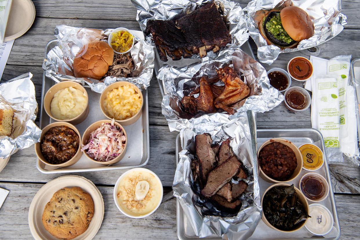 A spread of food available at Smoked! BBQ in Asheville, including brisket, ribs, and multiple sides.