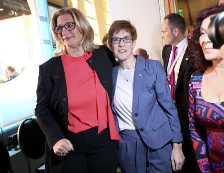 Annegret Kramp-Karrenbauer, State Minister-President and top candidate of the Christian Democratic Union Party (CDU) and Anke Rehlinger, top candidate of the Social Democratic Party (SPD) (L) reacts on first exit polls after the Saarland state elections in Saarbruecken, Germany, March 26, 2017. REUTERS/Kai Pfaffenbach