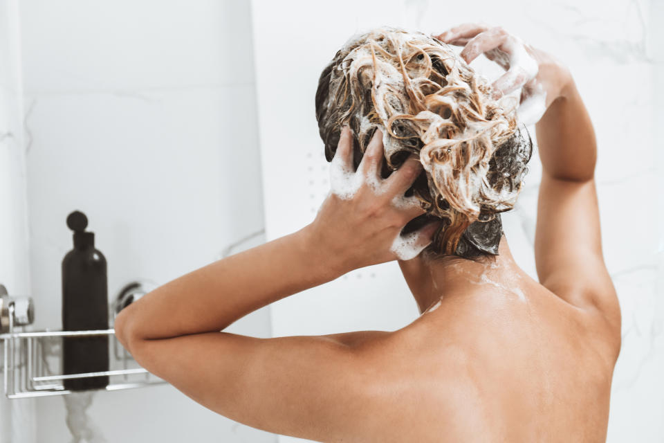 back of woman washing hair