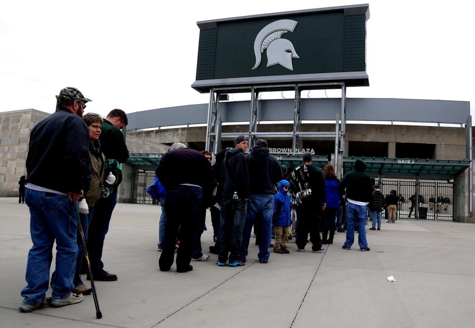 Fans line up outside Spartan Stadium before the gates opened at 12:30 pm for the 2 pm star of the Michigan State Spartans annual spring football game at Spartan Stadium in East Lansing, Michigan on Saturday, April 25, 2015.