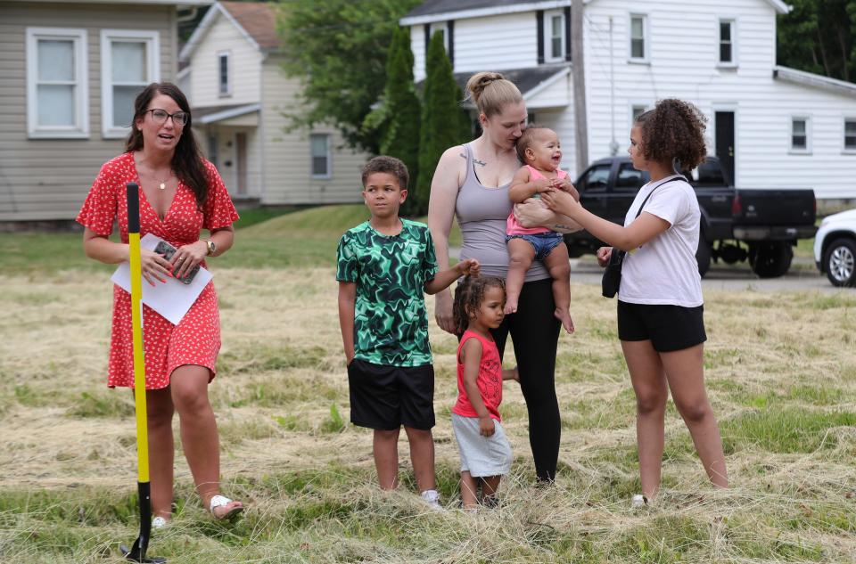 Niki Mcllvain, executive director of Alliance Area Habitat for Humanity, left, introduces Sara Kurzinsky and her children before they broke ground Monday, June 17, 2024, on their new home at Green Avenue and Noble Street.