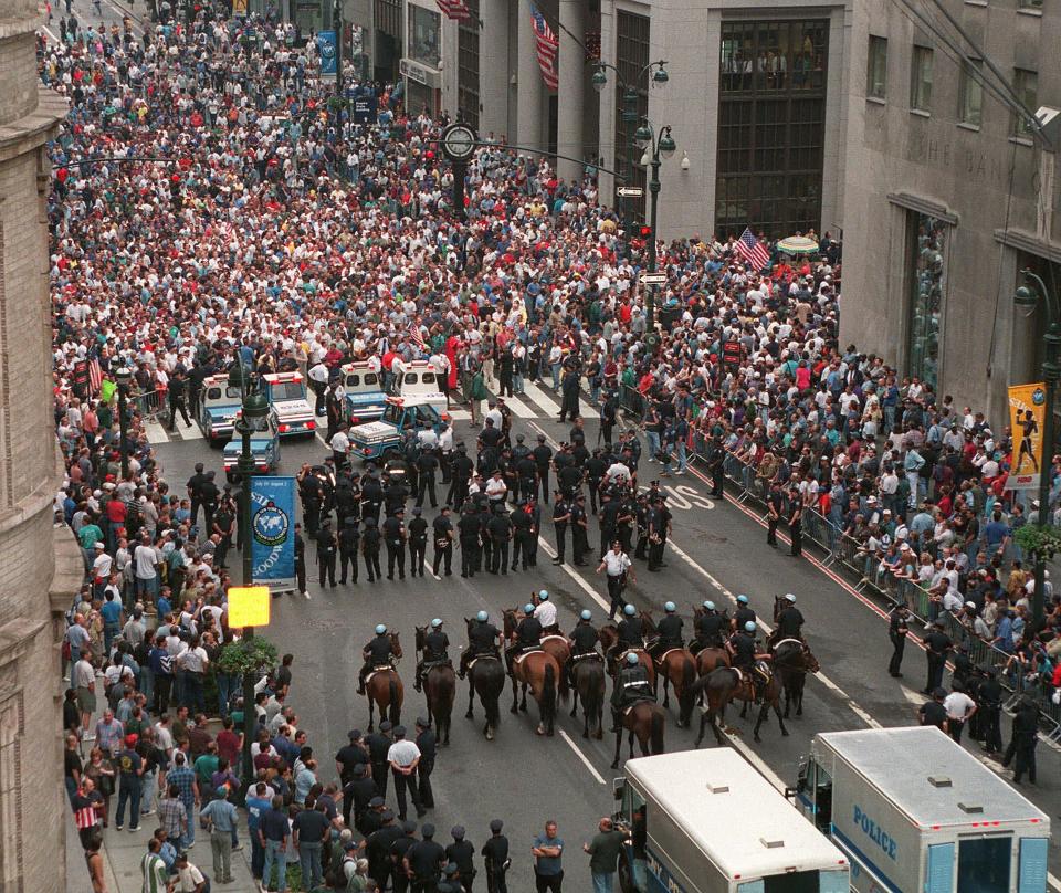 New York City police, including mounted officers, face a crowd of union protesters on Fifth Avenue, Tuesday, June 30, 1998, in New York. A large, noisy demonstration by thousands of construction workers tied up midtown Manhattan and disrupted business during the morning rush Tuesday. (AP Photo/Marty Lederhandler)