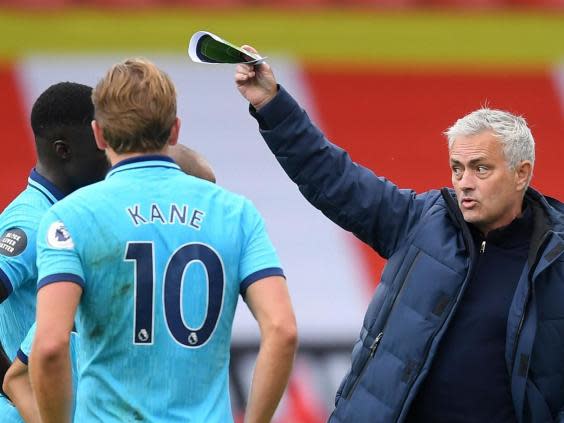 Tottenham Hotspur head coach Jose Mourinho (right) with his players (POOL/AFP via Getty Images)