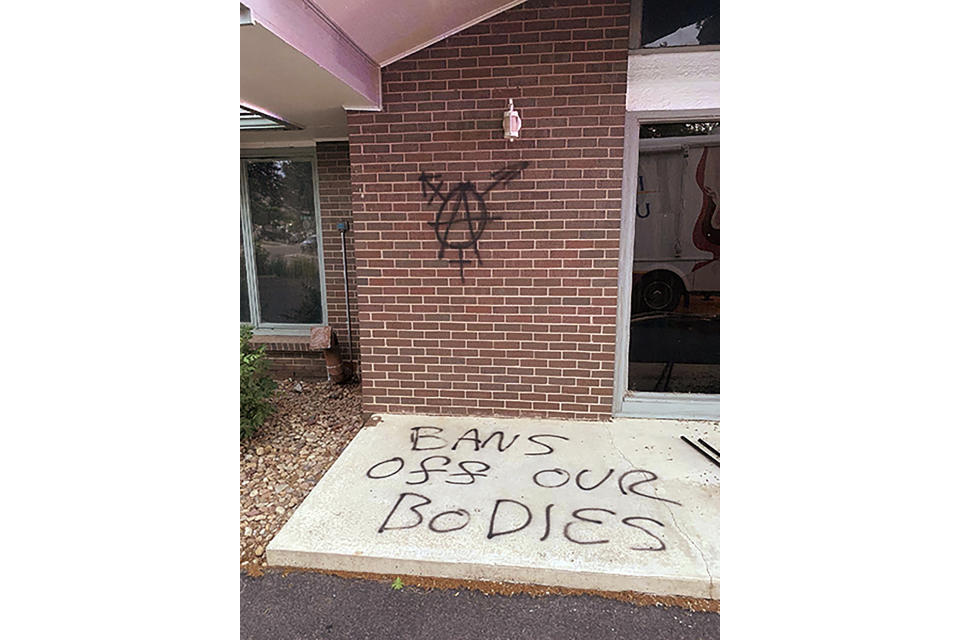 In this photo released by the Longmont Police Department, the Life Choices building in Longmont, Colo., is seen vandalized on Saturday, June 25, 2022, following a fire at the Christian pregnancy center. The fire, which is being investigated by police as a possible arson, was reported hours after the U.S. Supreme Court overturned Roe v. Wade and said abortion laws would be decided by the states. (Longmont Police Department via AP)