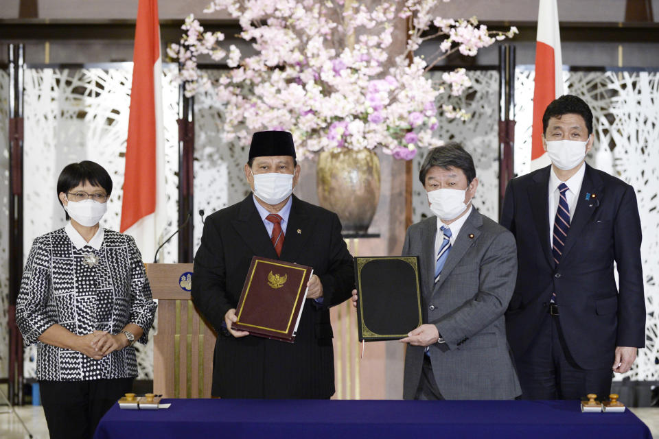Indonesian Foreign Minister Retno Marsudi, from left, Defense Minister Prabowo Subianto, Japanese Foreign Minister Toshimitsu Motegi and Defense Minister Kishi Nobuo pose for a photo during a signing ceremony for their foreign and defense ministers' meetings in Tokyo on Tuesday, March 30, 2021. (David Mareuil/Pool Photo via AP)