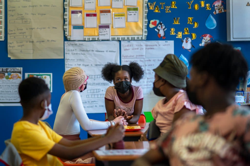 Pupils wearing masks study at the Kgololo Academy in Johannesburg's Alexandra township on Tuesday (AP)