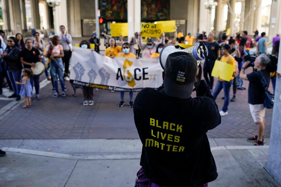 Protesters chant a slogan outside the Los Angeles City Hall in Los Angeles, Tuesday, Oct. 18, 2022.
