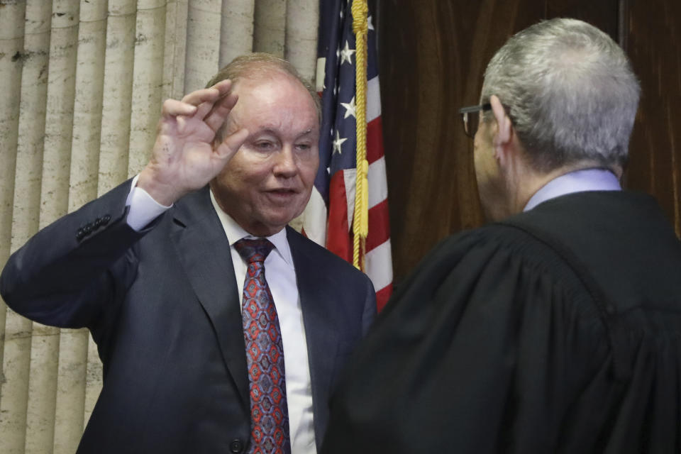 In this Aug. 23, 2019 photo, former U.S. Attorney Dan Webb takes the oath of special prosecutor before Judge Michael Toomin, during an status hearing concerning actor Jussie Smollett at the Leighton Criminal Court building, in Chicago. The latest twist in the Jussie Smollett saga is the revelation of a possible conflict of interest by the special prosecutor investigating why prosecutors dropped charges accusing the actor of staging a racist, homophobic attack on himself. Dan Webb disclosed this week he once co-hosted a political fundraiser for a figure central to his investigation, Cook County State's Attorney Kim Foxx. A Cook County judge must now decide if bias or the appearance of bias renders Webb's position untenable.(Antonio Perez/ Chicago Tribune via AP, Pool)
