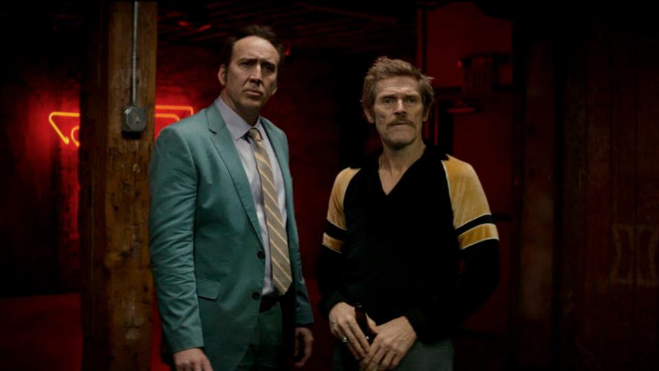 Nicolas Cage and WIllem Dafoe standing next to each other