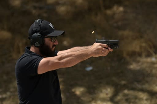 Rabbi Raziel Cohen, aka "Tactical Rabbi," shoots a Glock 9 mm pistol during a demonstration at the Angeles Shooting Ranges in Pacoima, California on May 20, 2019