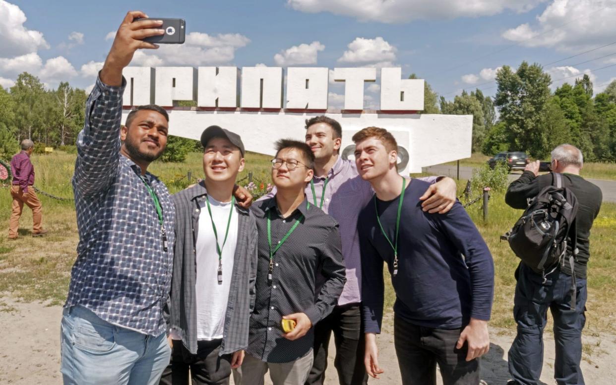 Tourists take a selfie in the ghost town of Pripyat, which has seen visitor numbers skyrocket after the HBO series about the 1986 meltdown at the Chernobyl nuclear power plant there - Bloomberg