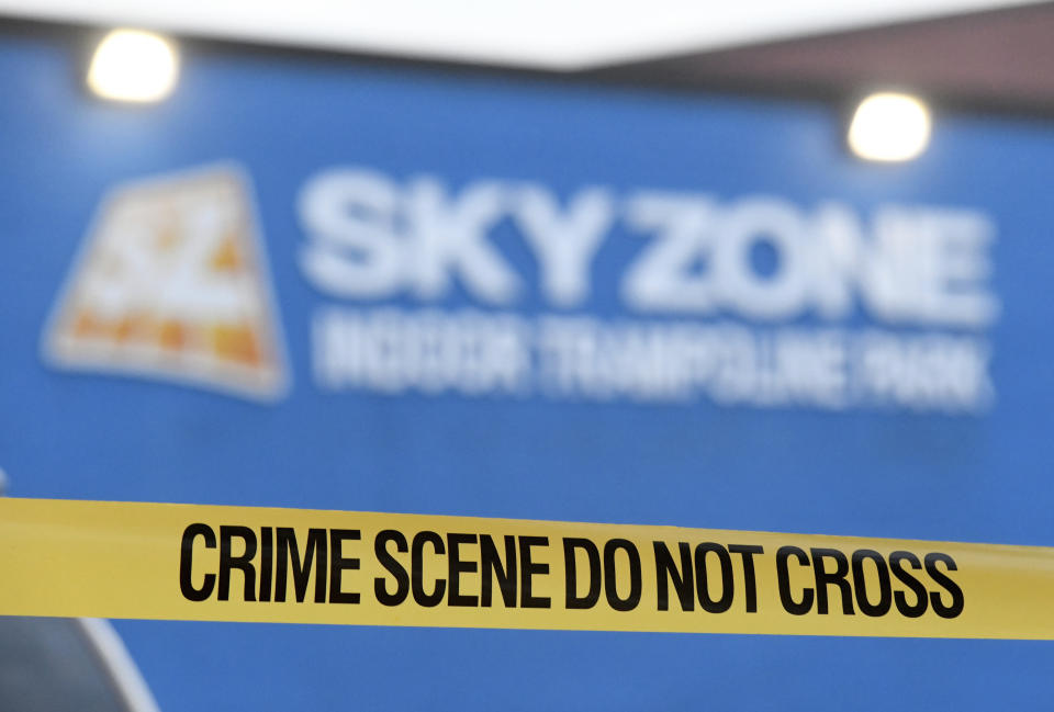 Crime scene tape hangs outside a Sky Zone trampoline park in Timonium, Md., after shots were fired, according to police, Saturday, Aug. 12, 2023. (AP Photo/Steve Ruark)