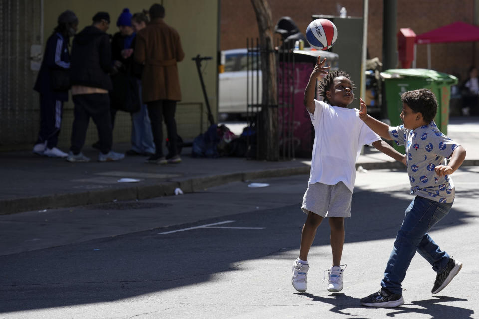 Children play with a basketball in the Tenderloin neighborhood Saturday, April 20, 2024, in San Francisco. (AP Photo/Godofredo A. Vásquez)